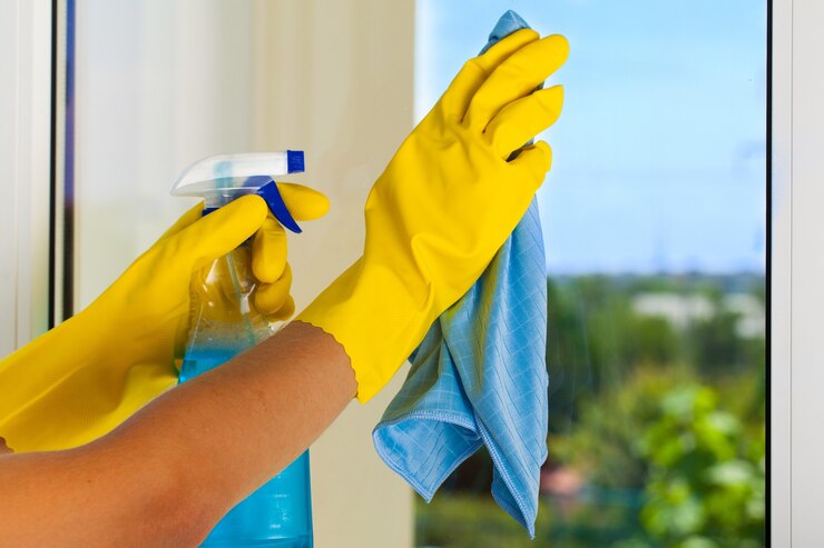 gloved-hands-cleaning-window-with-rag_488220-8850
