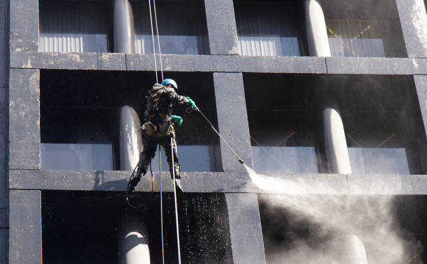 Vancouver, Canada - April 2,2020: Construction worker power washes windows one of the office buildings in Downtown Vancouver