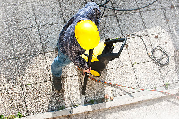 Young men cleaning  terrace  with high-pressure