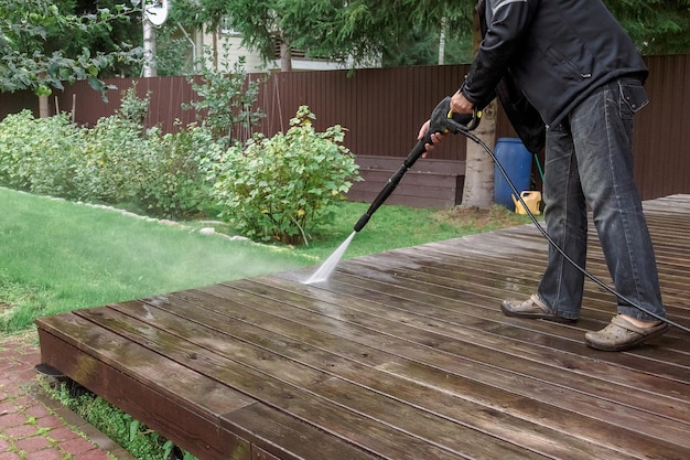 man-cleaning-walls-floor-with-high-pressure_114589-1273 (1)